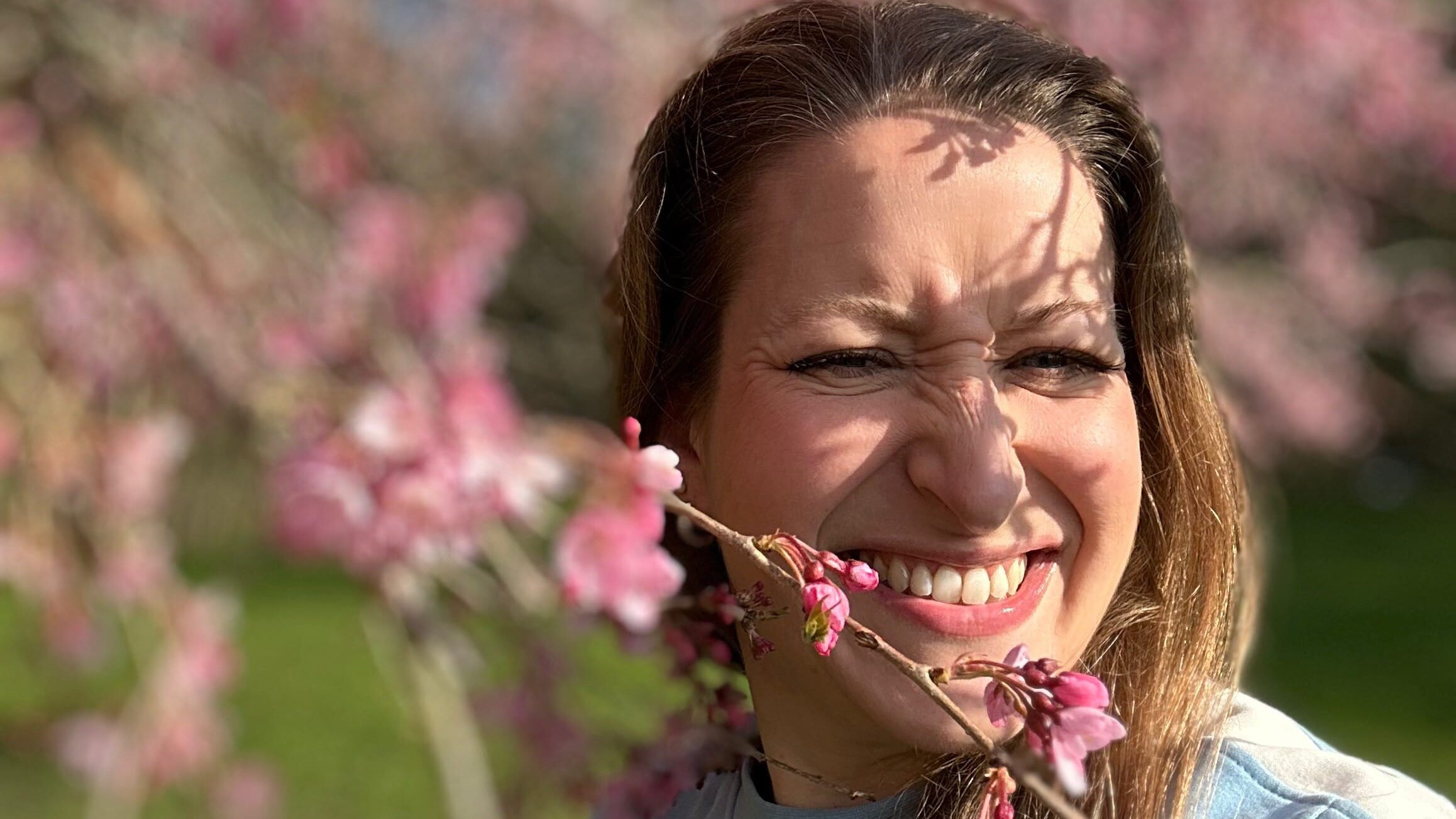Camilla Dyer laughing under the blossom tree in spring sunshine — female founder wellbeing, ERA Life First launch day 2026