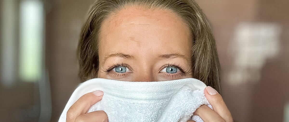 Camilla Dyer, founder of ERA Life First — woman holding white towel, eyes looking directly to camera — female founder wellness uncomplicated